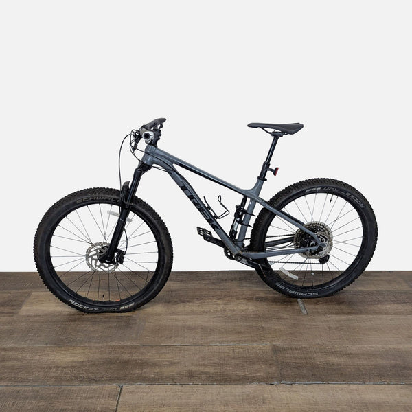 1. Grey Trek full suspension mountain bike with disc brakes and knobby tires, ideal for trail and outdoor riding.