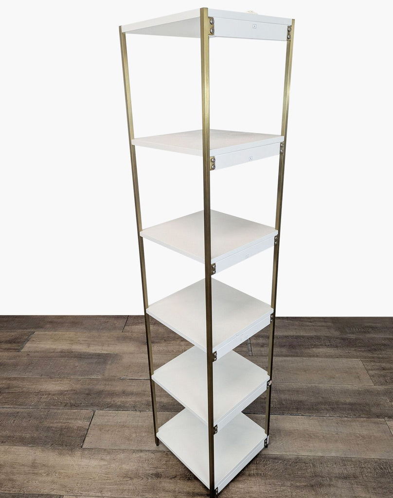 2. Side angle of Blair Bookcase in white and gold, showing sleek, open shelving and modern iron frame.  