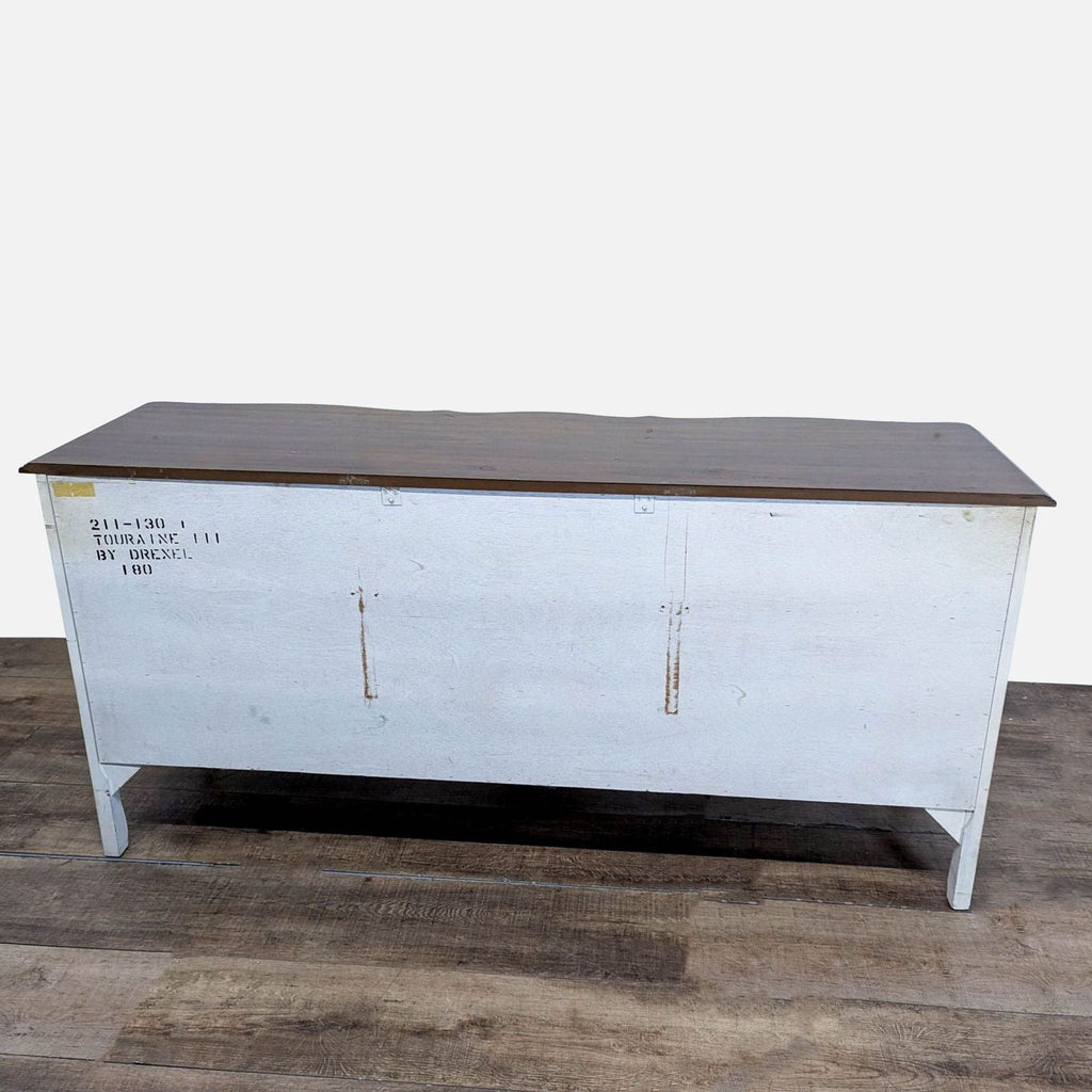 2. Rear view of Drexel Heritage dresser showing label and wood grain top, painted in light color.