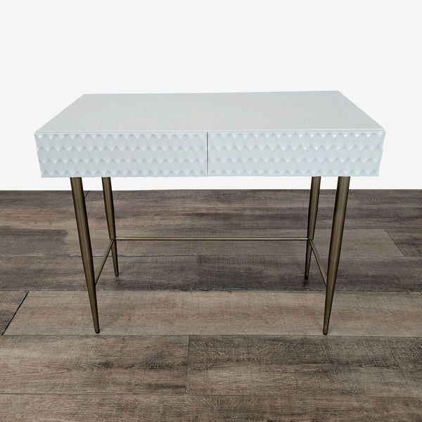 1. West Elm desk with geo-textured white drawer fronts and antique brass metal legs, viewed from the front.