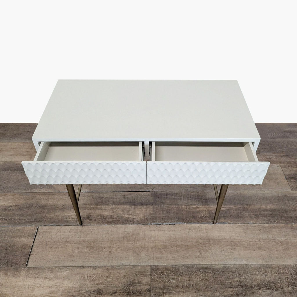 2. West Elm desk showing open drawers with geometric textured fronts and antique brass finish legs.