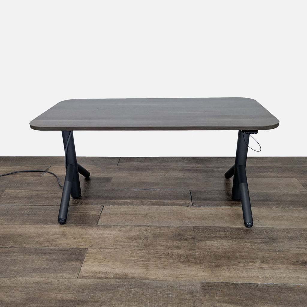 1. Steelcase desk with adjustable height, integrated power options, and wheels for mobility, on wood floor.  