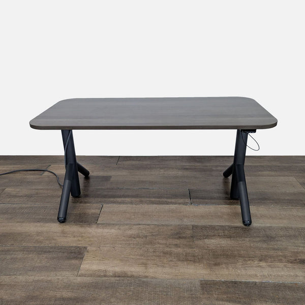 1. Steelcase desk with adjustable height, integrated power options, and wheels for mobility, on wood floor.  