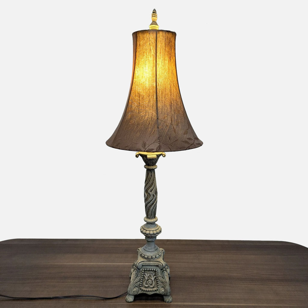 Ornate vintage-style Reperch table lamp with a fabric shade, displayed on a wooden surface.  