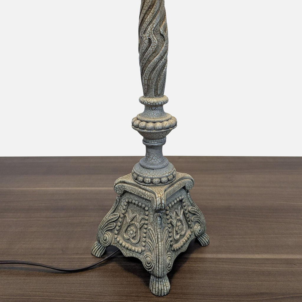 Close-up of the ornate, antique-inspired base of a Reperch table lamp from the Lighting category.