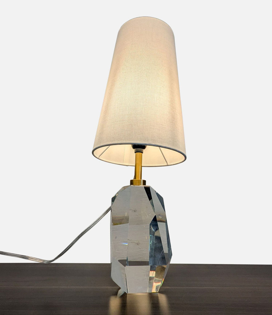 1. Crystal lamp by Lillian August with a tapered linen shade, featuring a faceted architectural base on a table.