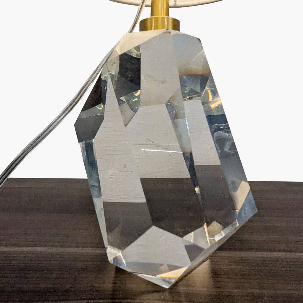 2. Close-up of a Lillian August lamp's geometric crystal base, showing clear angular facets and gold hardware.