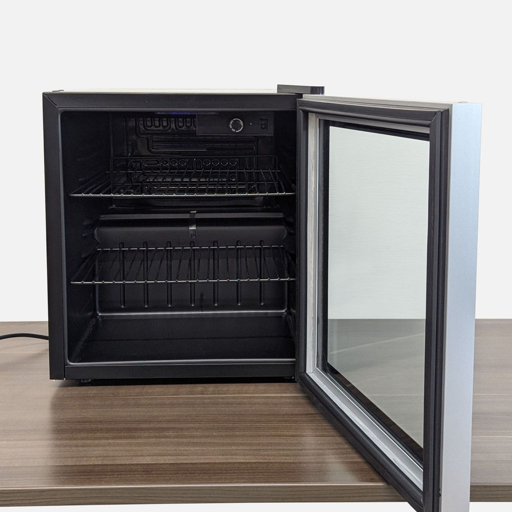 2. Interior view of Antarctic Star fridge with open glass door and adjustable wire shelves for storage.  