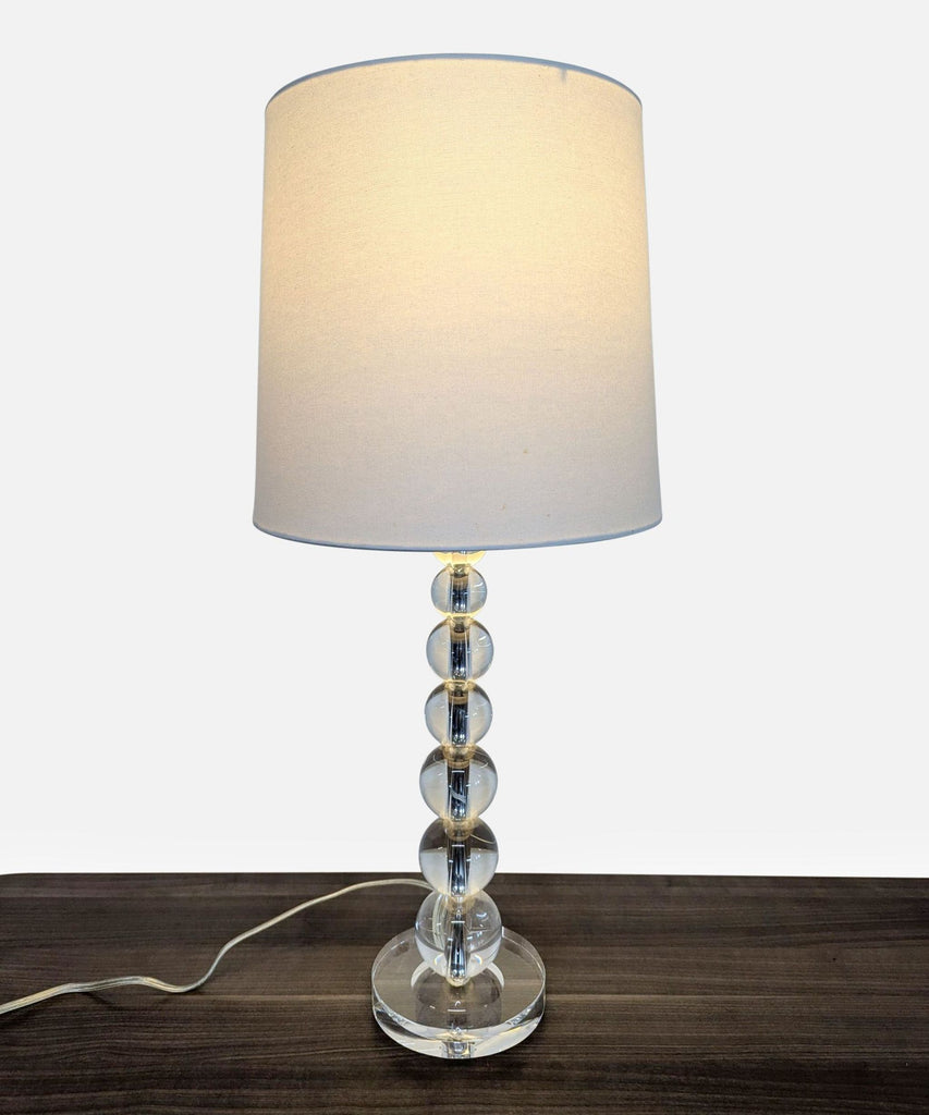 3. Modern table lamp from Pottery Barn, featuring stacked crystal orbs base and cylindrical linen shade.