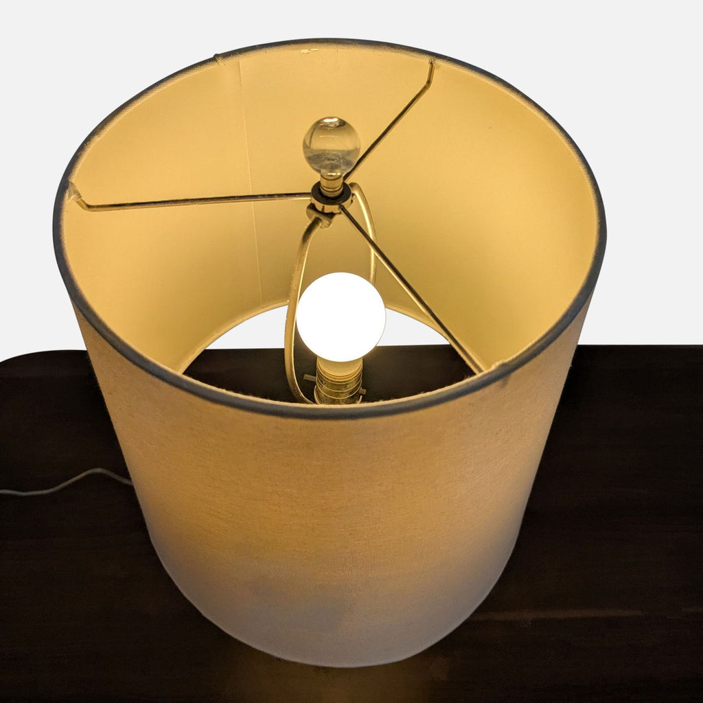 2. Top-down view of Pottery Barn lamp showing linen shade and lightbulb inside, crystal orb finial on top.