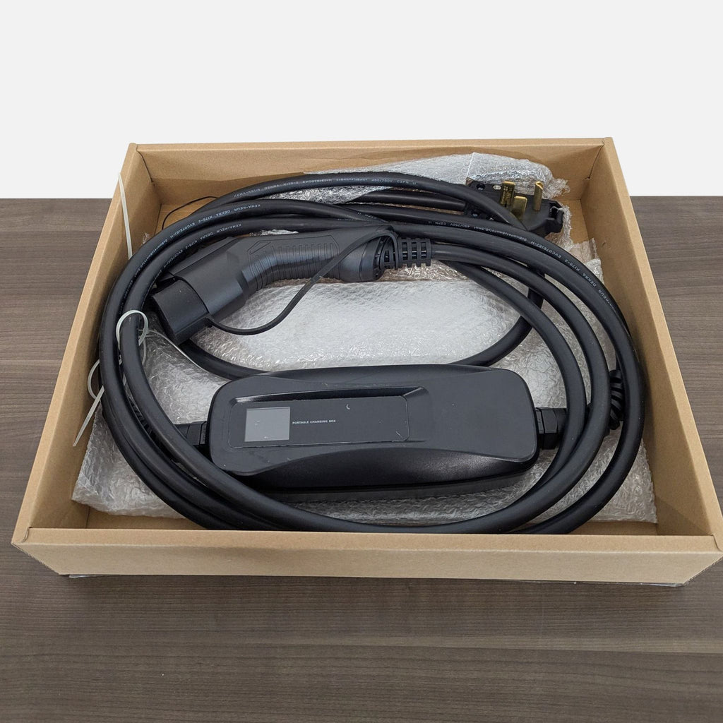 A portable electric vehicle charging box and cable, packaged securely in a cardboard box with foam padding.