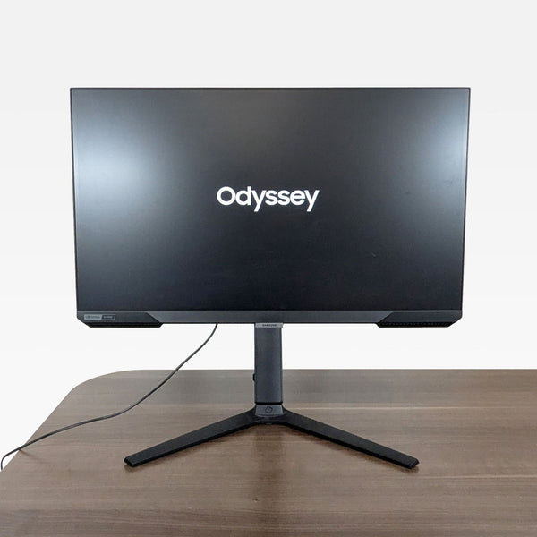1. Front view of a Samsung 27-inch Odyssey gaming monitor with a flat screen, on a desk.
