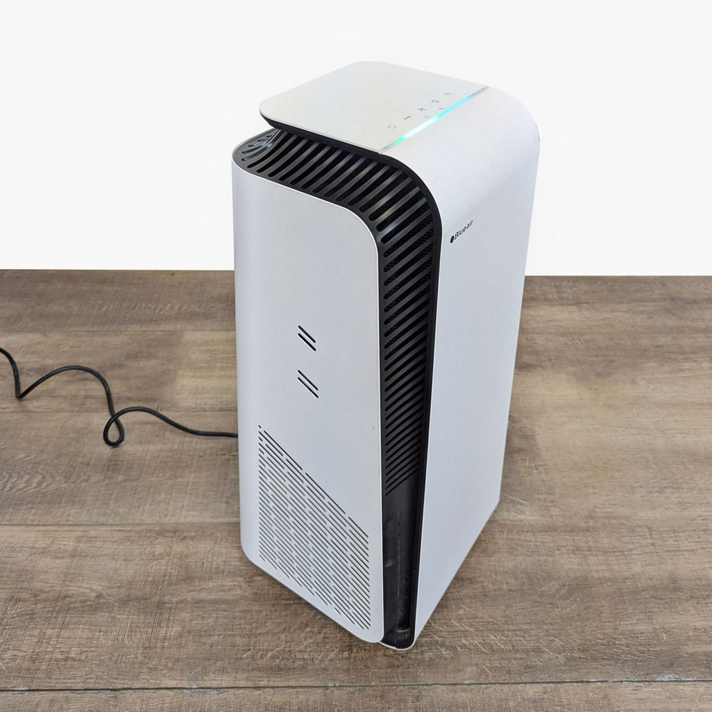 2. Angled view of a Blueair air purifier showing side vents, sleek shape, and easy-to-use top controls.