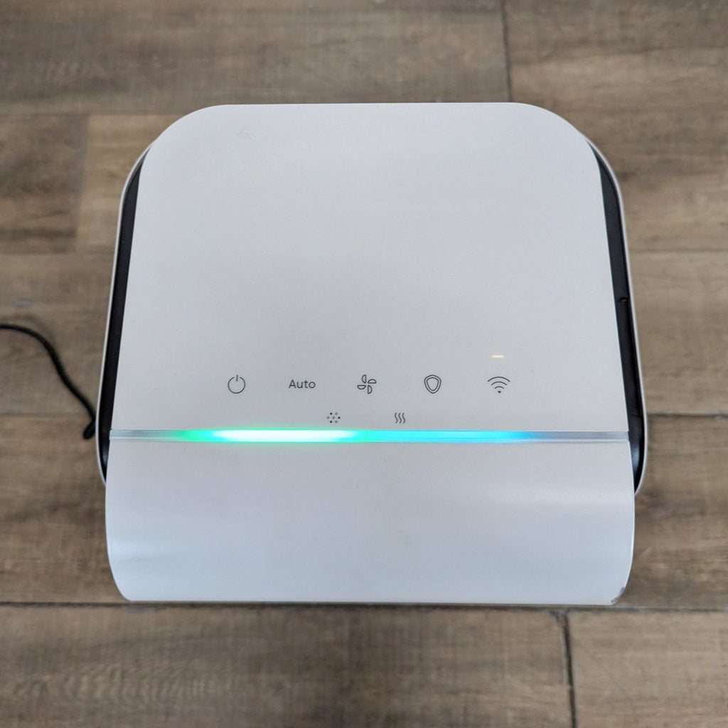 3. Close-up of Blueair air purifier touch control panel with illuminated indicators for power and settings.