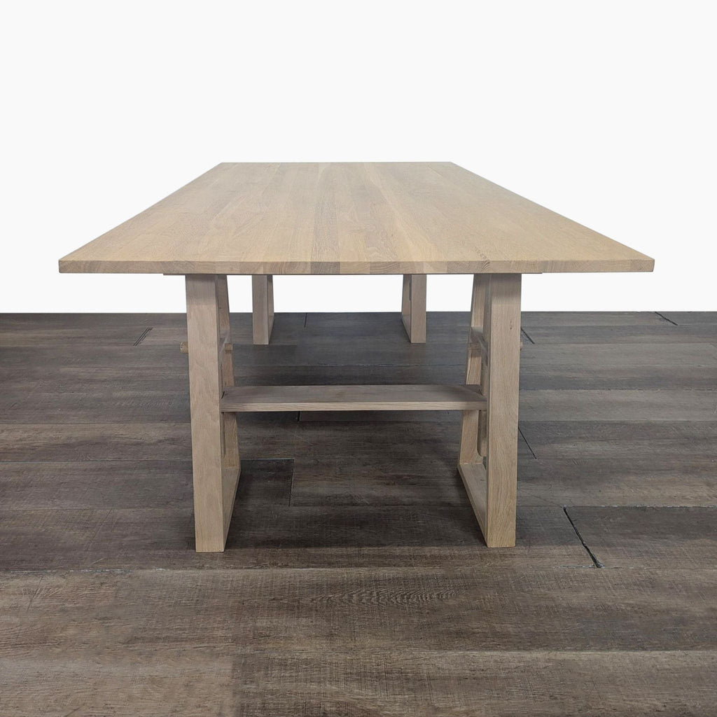 3. Industry West solid wood desk with a large rectangular top and adjustable trestle base frame.