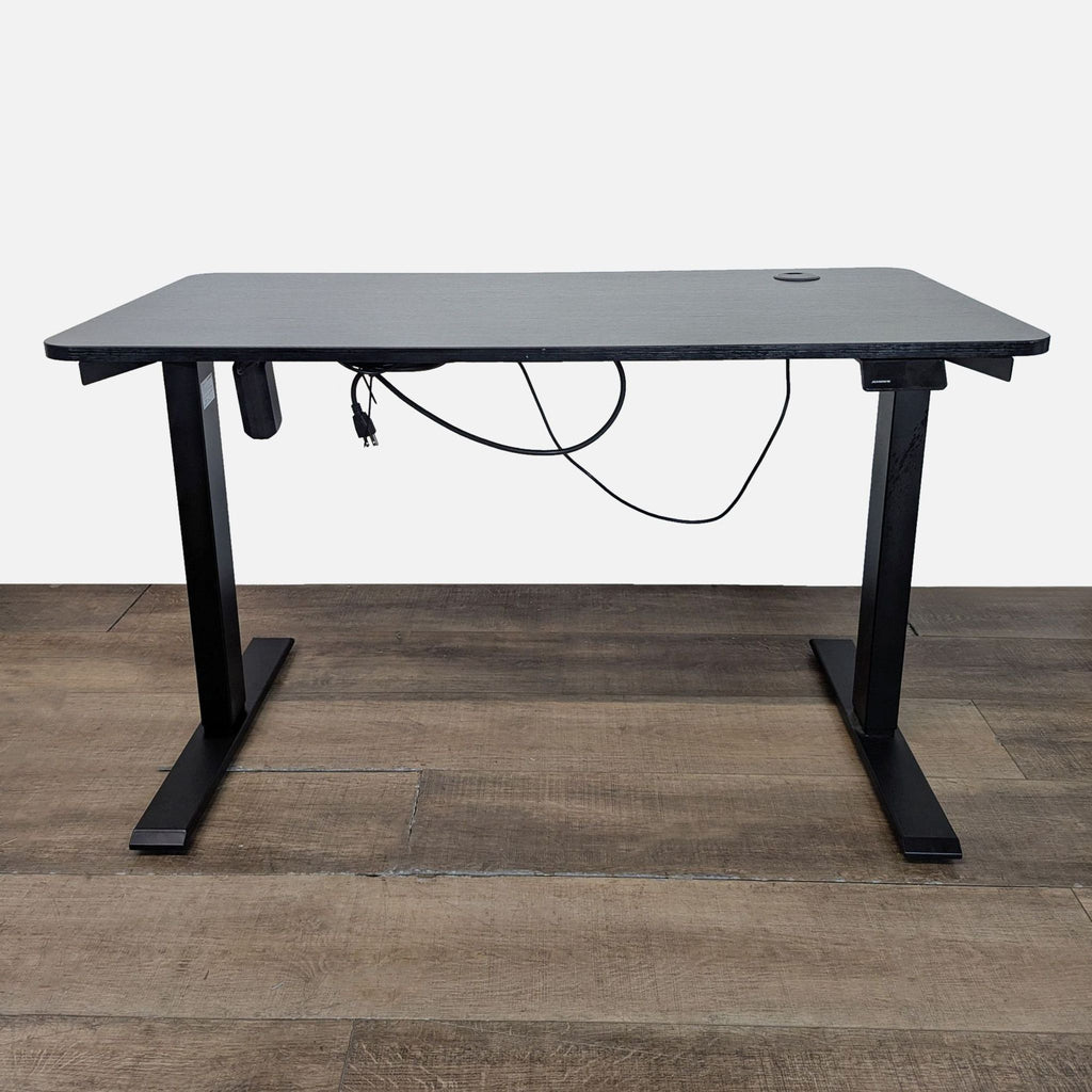 1. Maidesite desk with programmable height controller and cord management, shown on wood floor from the front.