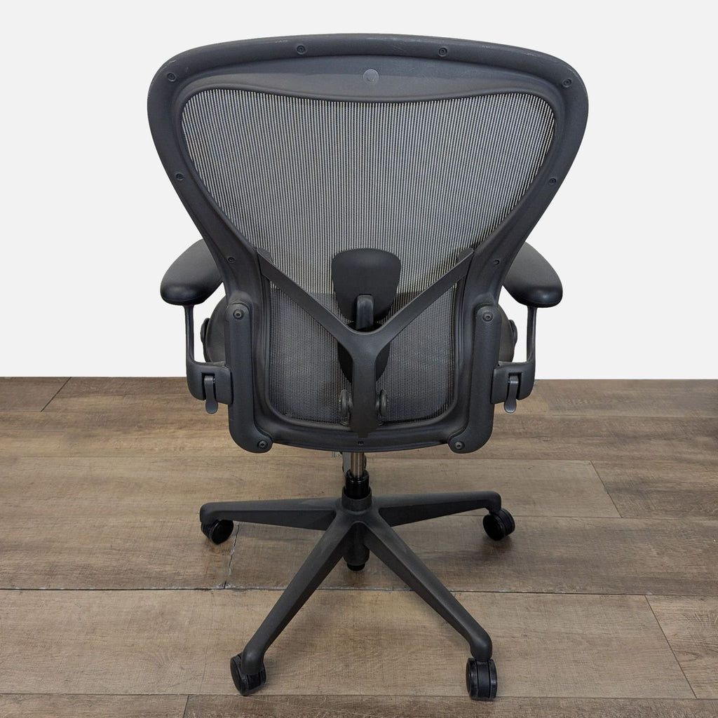 3. Rear view of a Herman Miller chair highlighting the Pellicle mesh back, lumbar support adjustment, and sturdy frame.