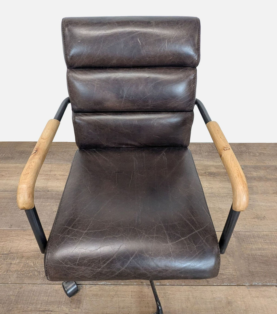 3. Overhead view of a Reperch tufted back chair, showing wood armrests and wheeled black frame.