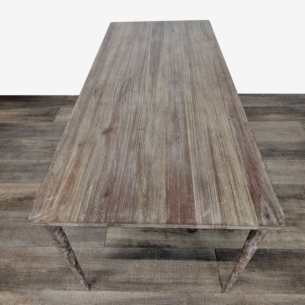 2. Top-down view of a West Elm dining table showing its long rectangular wood surface and minimalist design.