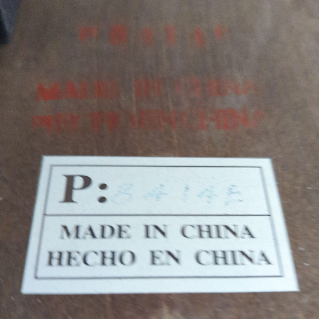 3. Label on the coffee table reads "Made in China / Hecho en China" with faded writing above.