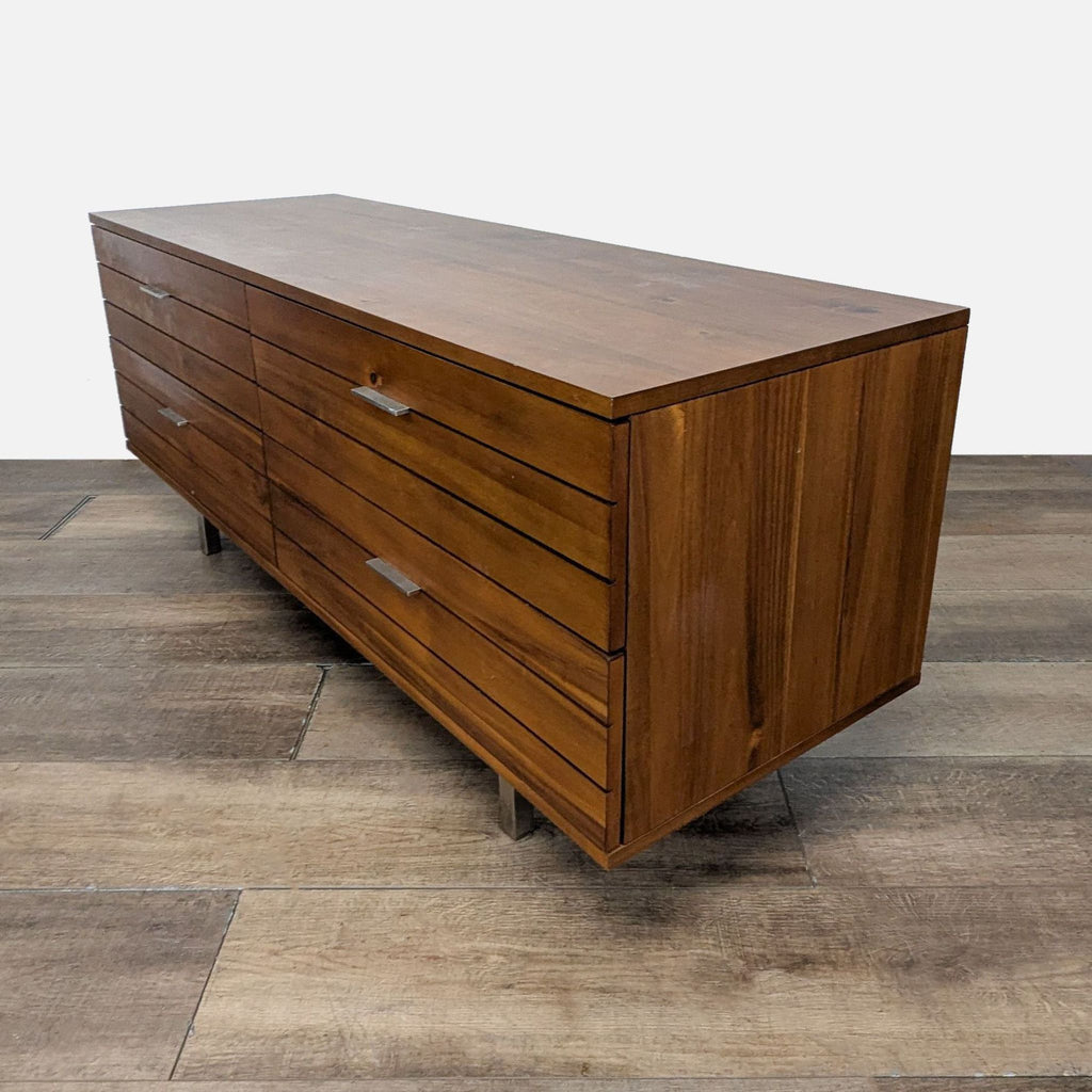2. CB2 wooden dresser in walnut, 6-drawer design with sleek handles, shown from an angled side view.