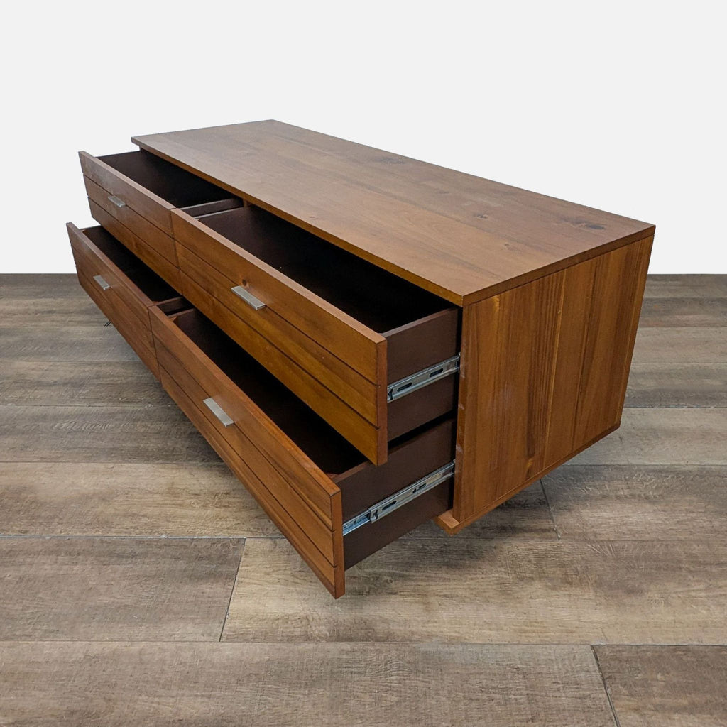 3. CB2 walnut dresser with six partially opened drawers, displaying spacious interior storage, side angle.