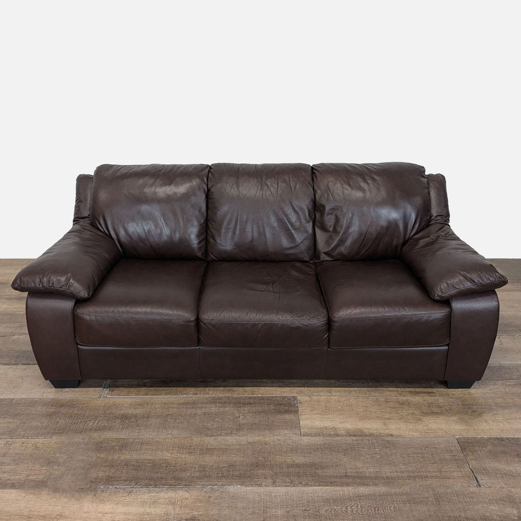 1. Natuzzi 3-seat sofa with plush cushions and brown leather upholstery, shown from the front view.