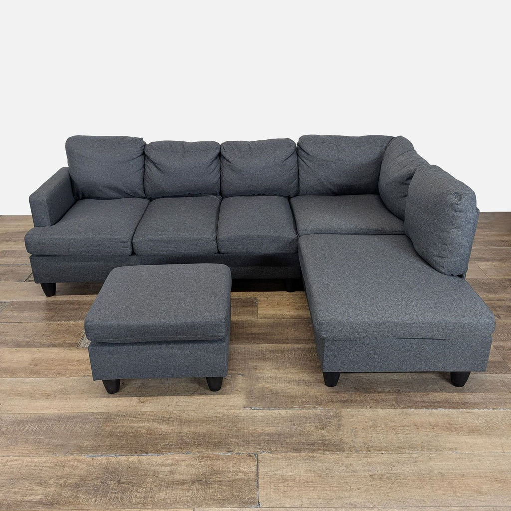 1. Modern dark gray Reperch sectional sofa with plush cushions and matching ottoman on wooden floor.