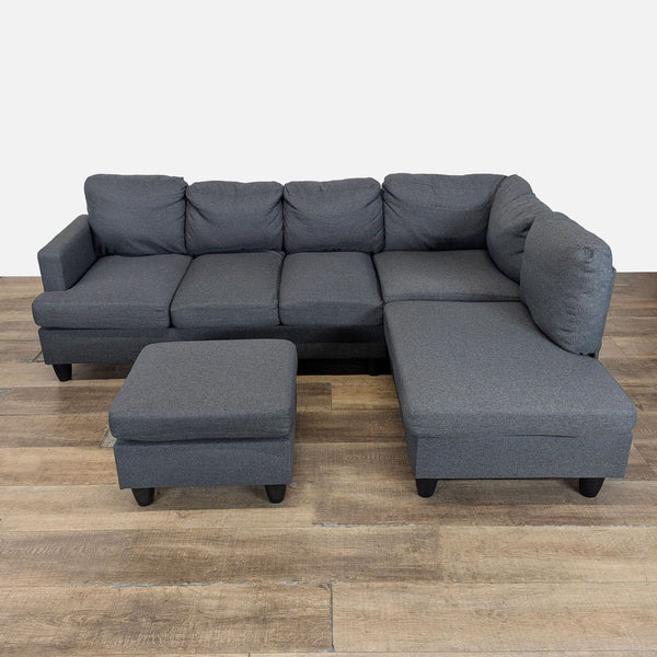 1. Modern dark gray Reperch sectional sofa with plush cushions and matching ottoman on wooden floor.