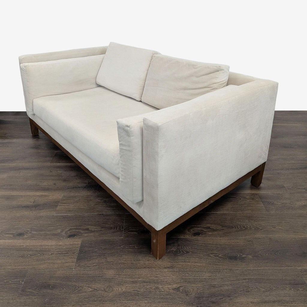 3. Rear angled view of Apt2B loveseat, highlighting washable hypoallergenic upholstery and sturdy wood base.