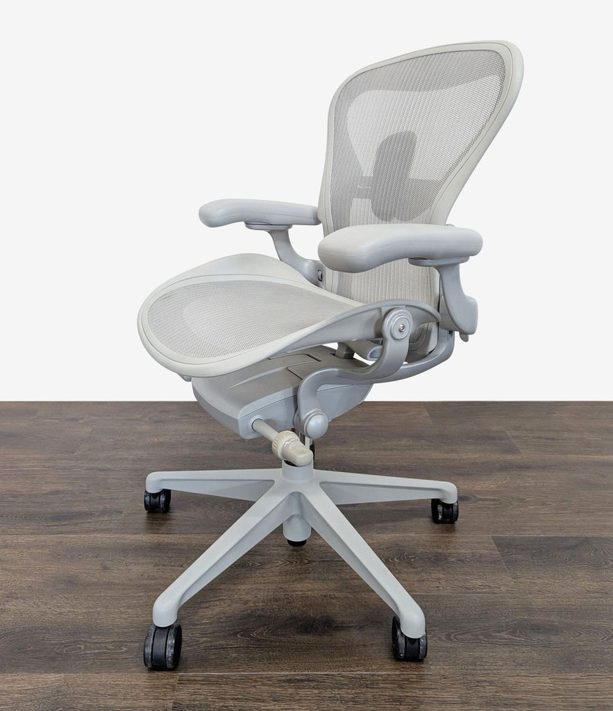 2. Side view of a high-performance Herman Miller office chair, featuring Pellicle mesh and adjustable armrests.  