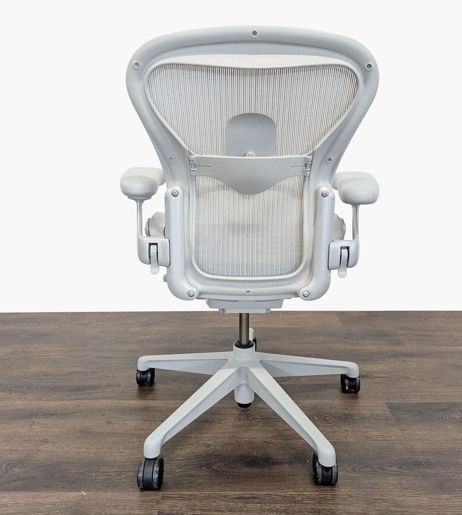 3. Rear view of a Herman Miller office chair showing mesh back, lumbar support, and a five-wheel swivel base.