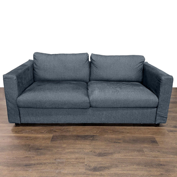 1. Front view of a dark gray Ikea sleeper sofa with plush cushions on a wooden floor.
