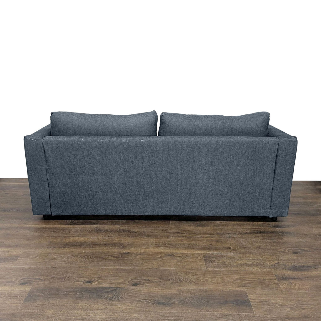 3. Rear view of a modern dark gray Ikea sleeper sofa, featuring straight lines and cushioned back.