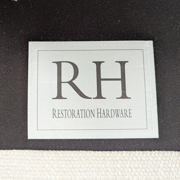 1. Restoration Hardware lounge furniture label on fabric, showcasing the RH brand tag in black and white.