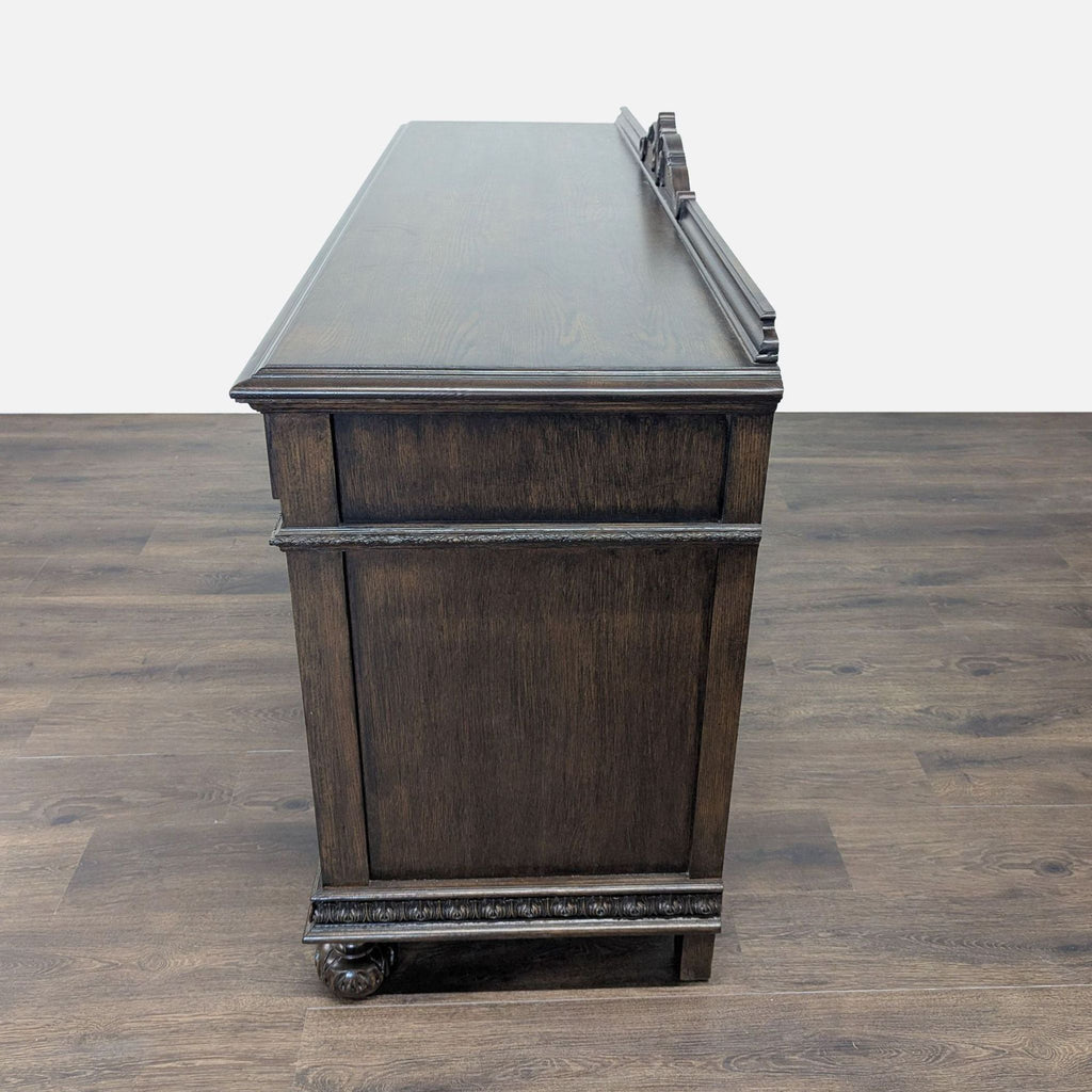 3. Side profile of a dark wood Reperch sideboard, highlighting smooth sides and decorative trim.