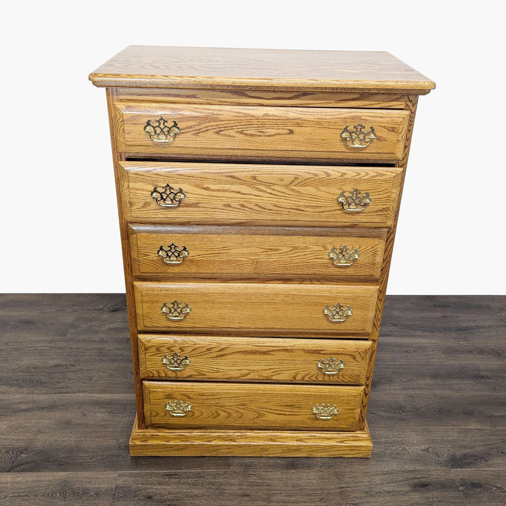 1. Front view of a classic oak dresser by Reperch, featuring six drawers with metal glides and ornate handles.