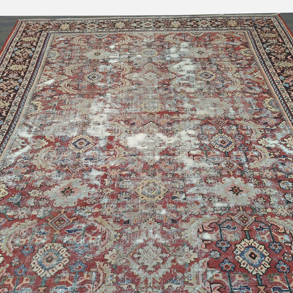 2. Close-up of Reperch vintage Persian wool rug displaying detailed motifs and visible faded areas in the center.