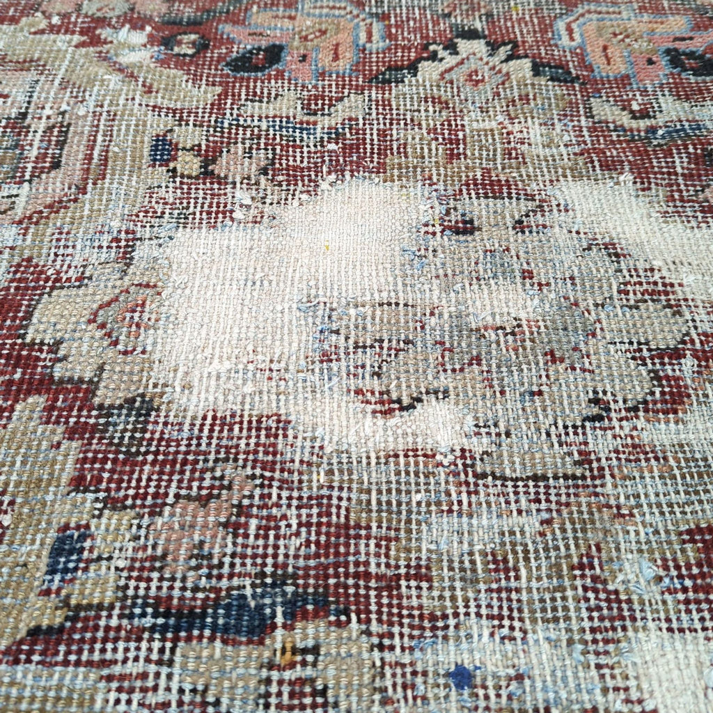 3. Detailed view of distressed section on vintage Reperch Persian rug, showing hand-knotted wool texture and faded colors.