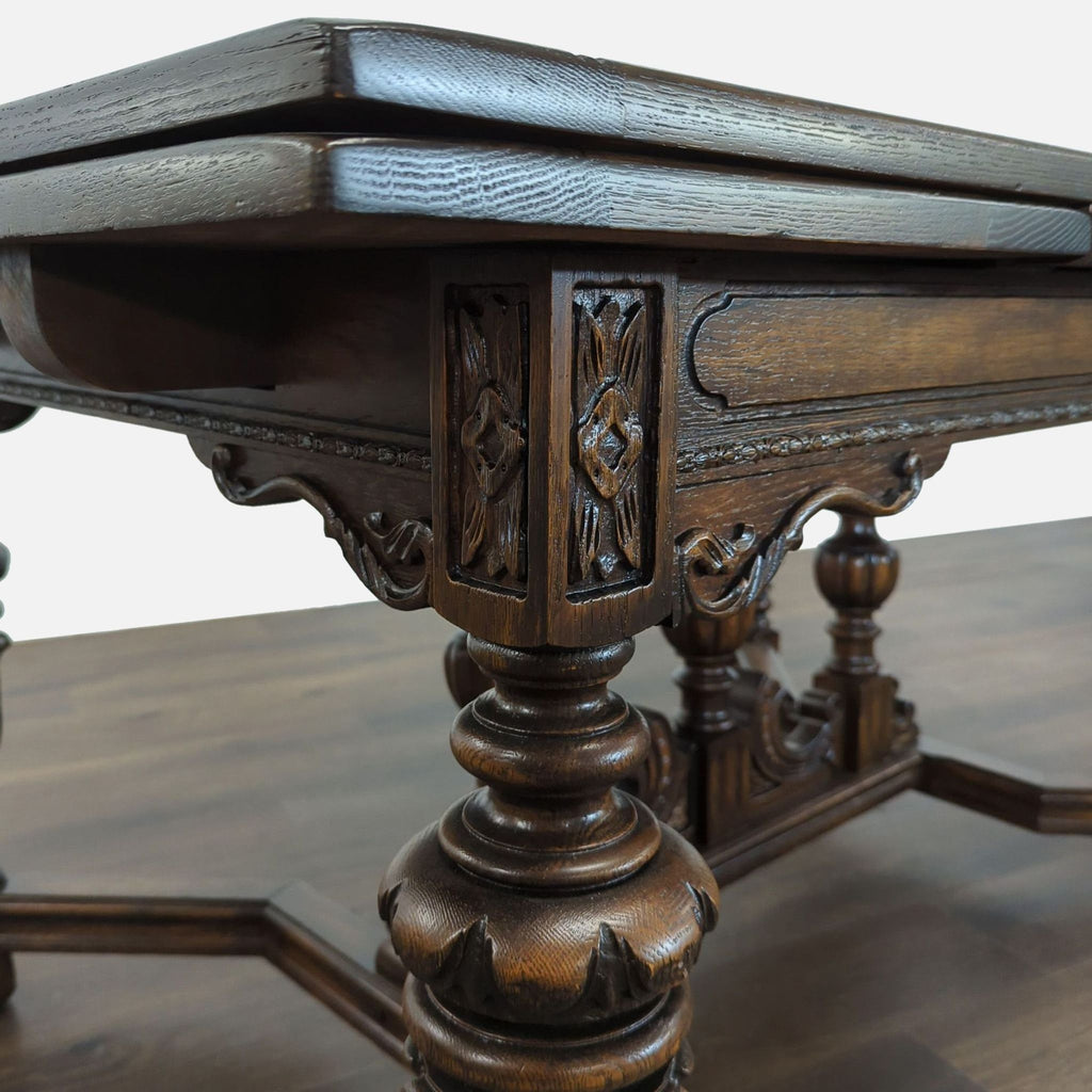 1. Close-up of ornate Reperch dining table leg, showing detailed wood carving and dark polished finish.