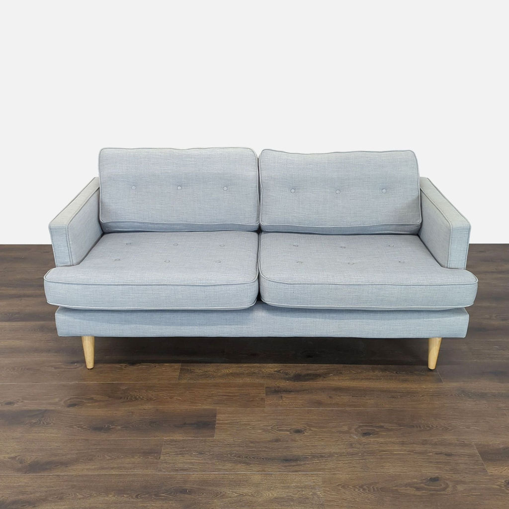 3. Full front view of Reperch Loveseat with light gray fabric, button details, and minimalist wooden legs.