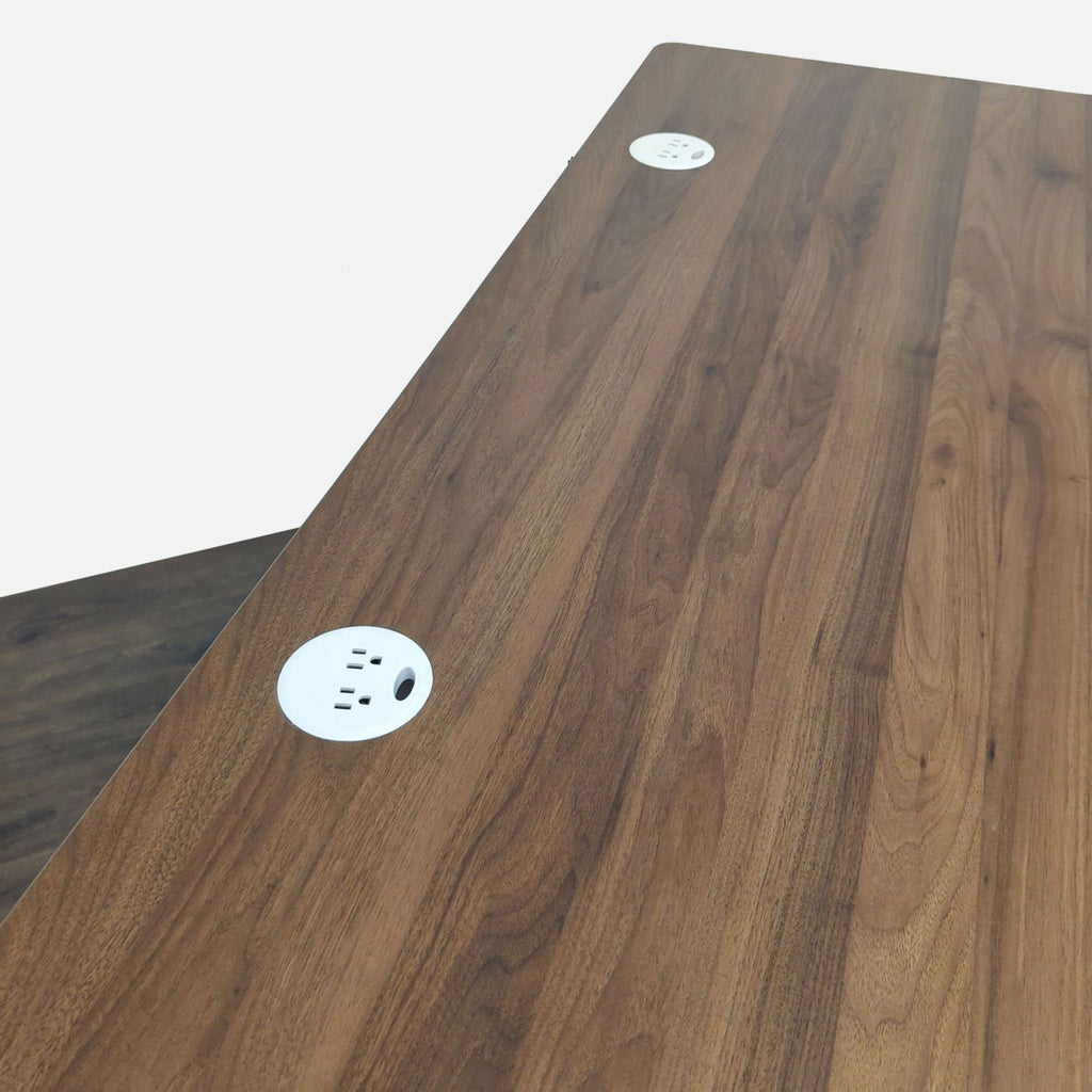 3. Walnut top UPLIFT desk with two round built-in power grommets for cable and device management.