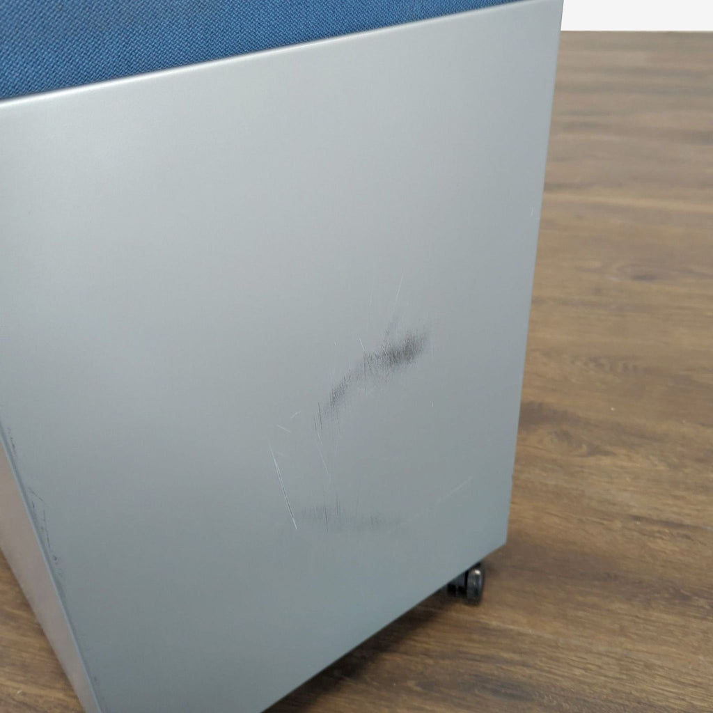 1. Close-up of a Reperch cabinet showing minor scuff marks and scratches on the lower gray side panel.