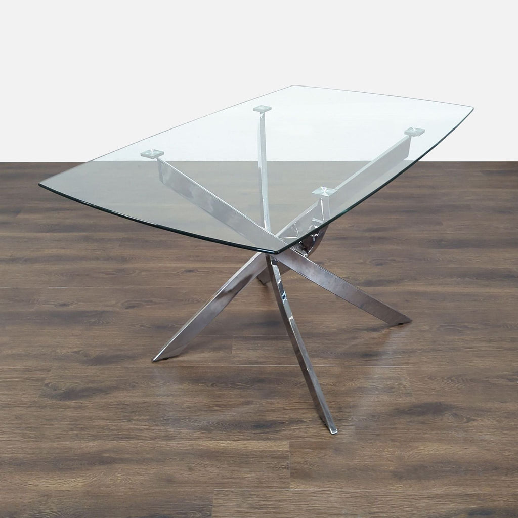 3. Rectangular Reperch dining table with clear glass top and chrome crossed metal base on wood floor.