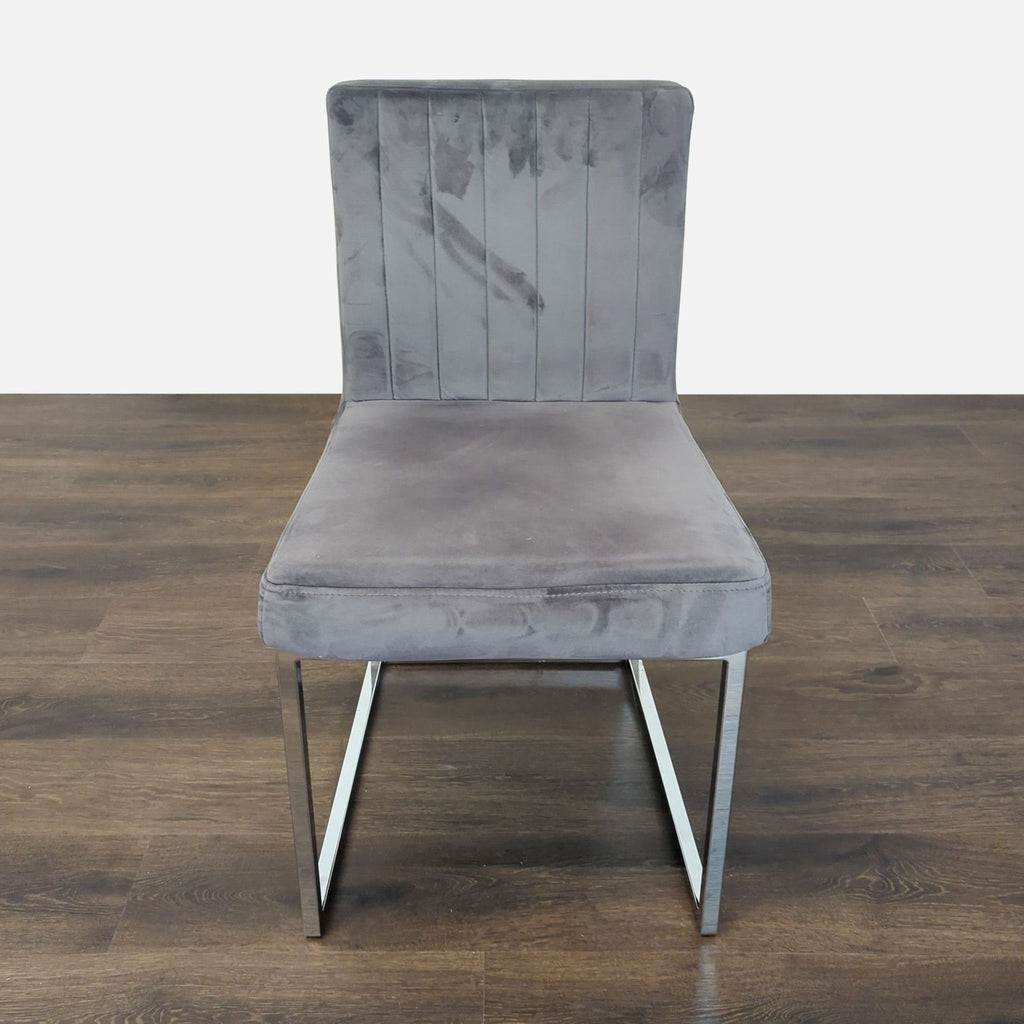 2. Modern Reperch dining chair with gray cushioned seat, metal legs, and a wide backrest on wood flooring.