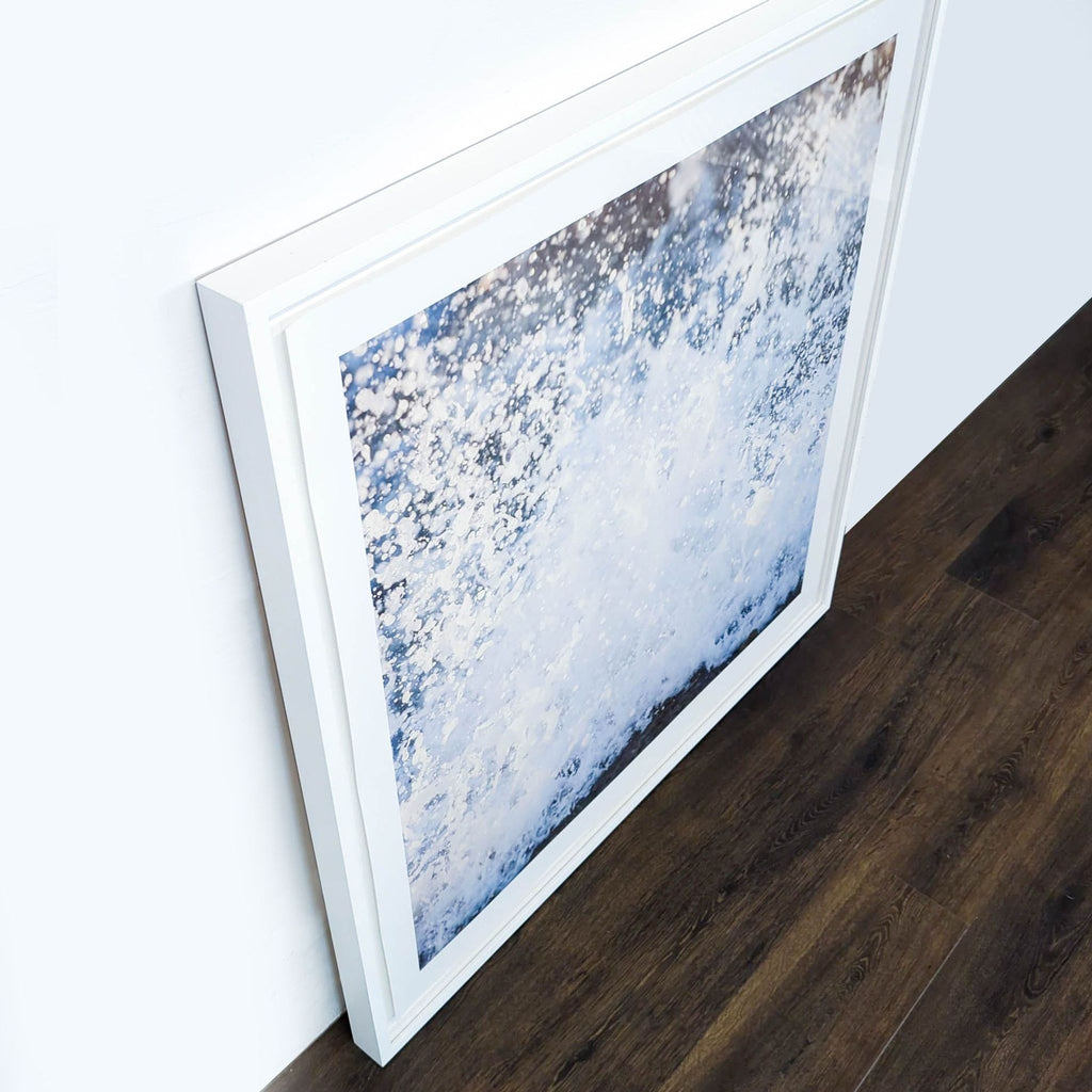 - Angled view of a Reperch framed print, showcasing a dynamic water splash image with a white frame.