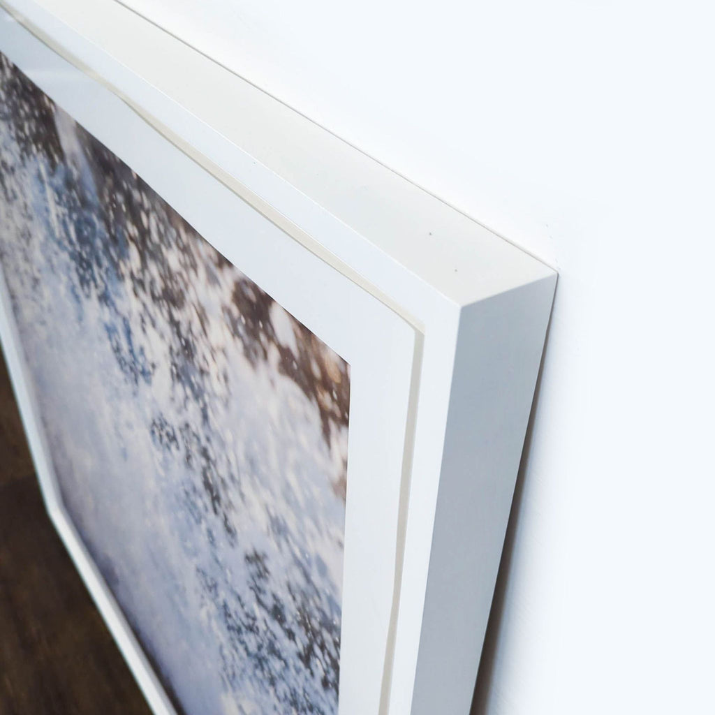 - Close-up of a white-framed Reperch art print with water splash design from the Prints & Maps category.