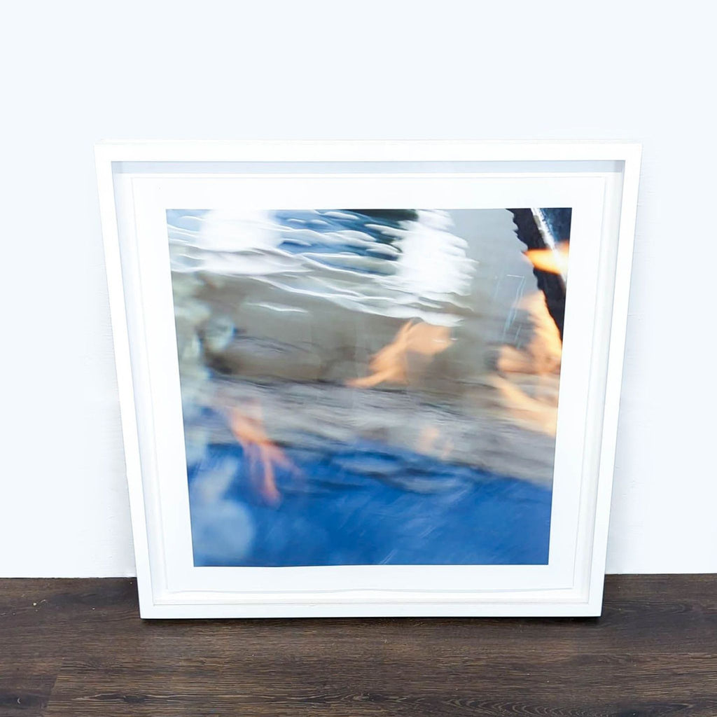 1. Abstract Reperch print in white frame, blue and orange tones, 26¼" square. Shown resting on floor.