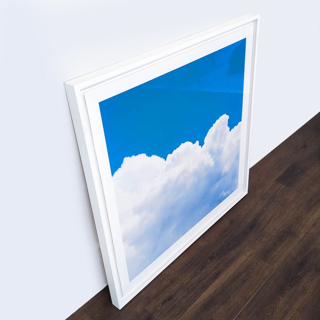 2. Angled view of a Reperch framed cloud print in blue and white, showing its depth and modern frame.