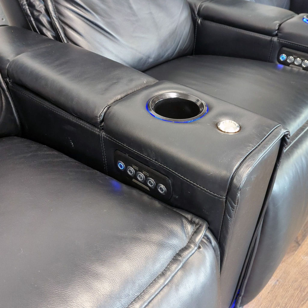 2. Close-up of an Octane black leather recliner armrest, showing cup holder and integrated control buttons.
